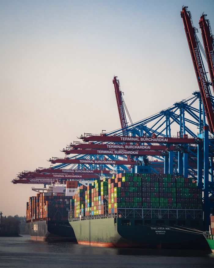 about-01 Cargo ships and cranes at Hamburg Burchardkai Terminal during day.